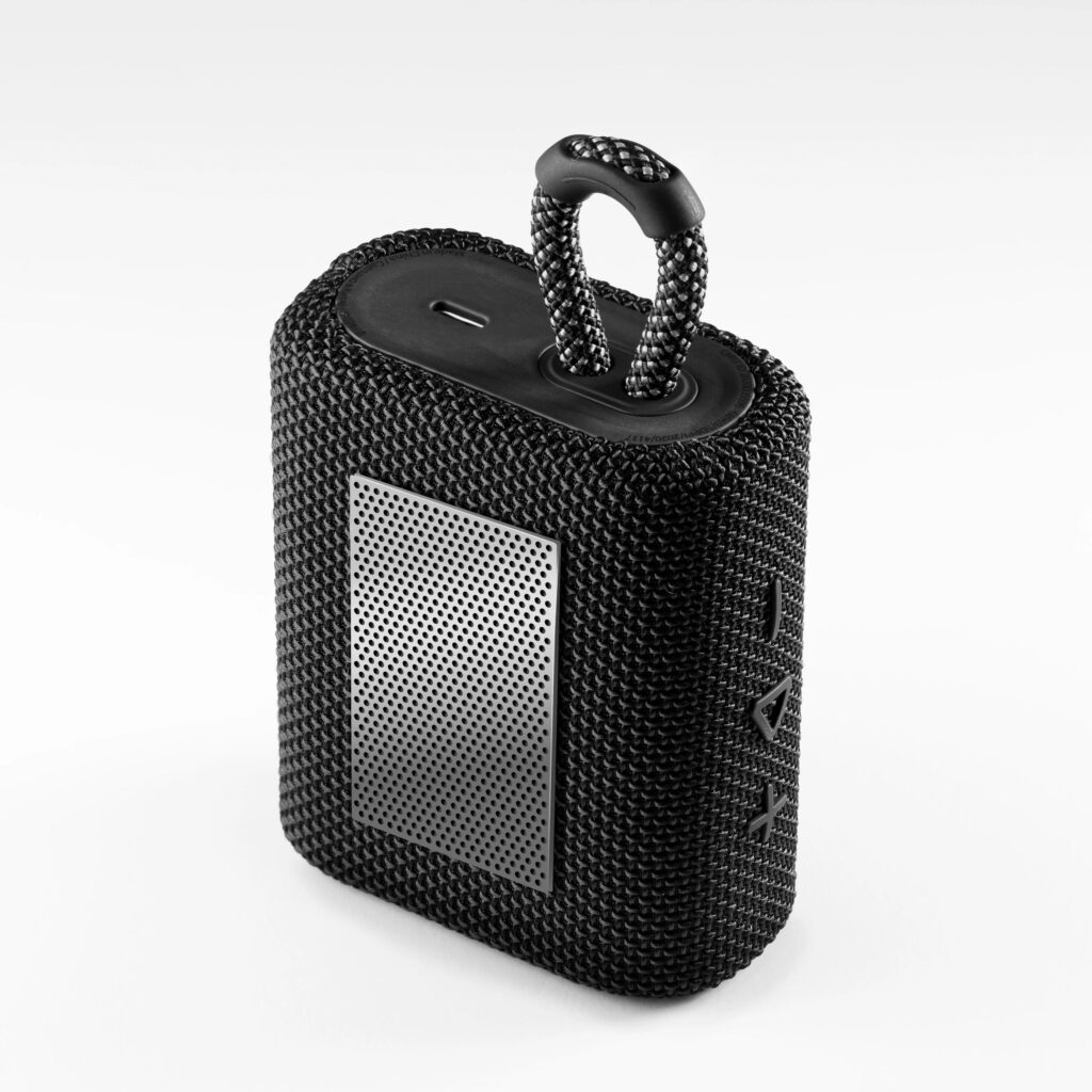 Portable Bluetooth speaker with compact black design on clean background